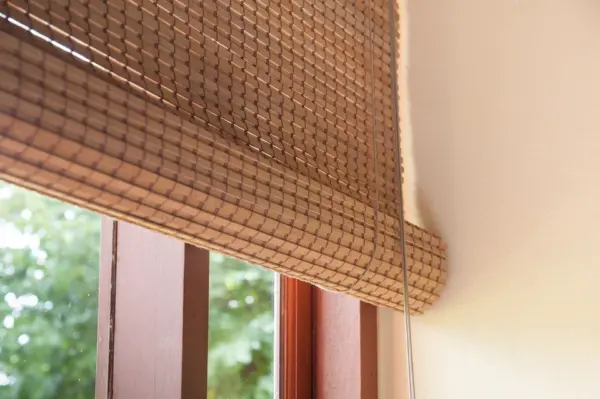 Bamboo Window Blind installed on yellow window frame.